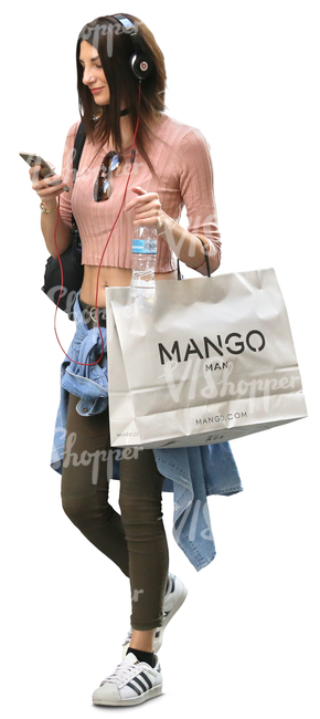 woman carrying a big shopping bag walking and listening to music