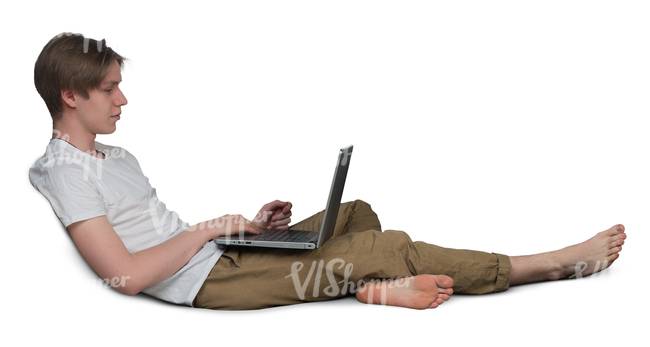 young man sitting on a couch and working with his laptop