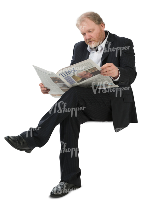 man in a suit sitting and reading a newspaper