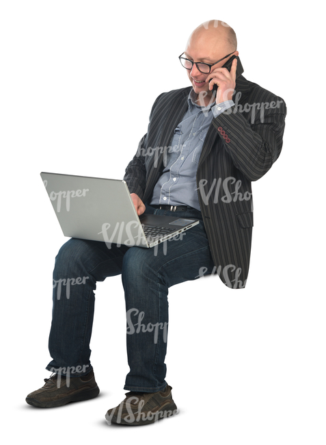 man sitting with a laptop on his knees and working