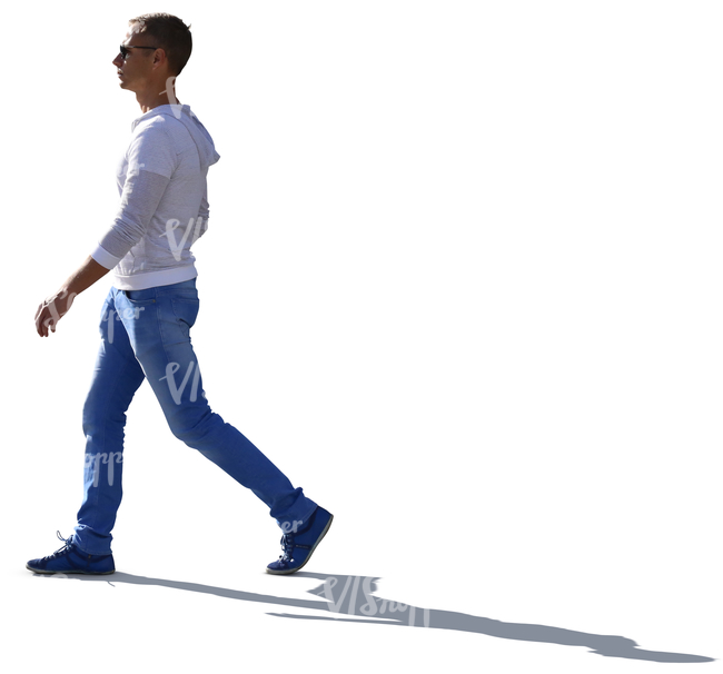 backlit young man in a white sweater walking