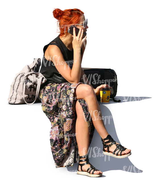 red haired woman sitting and talking on the phone