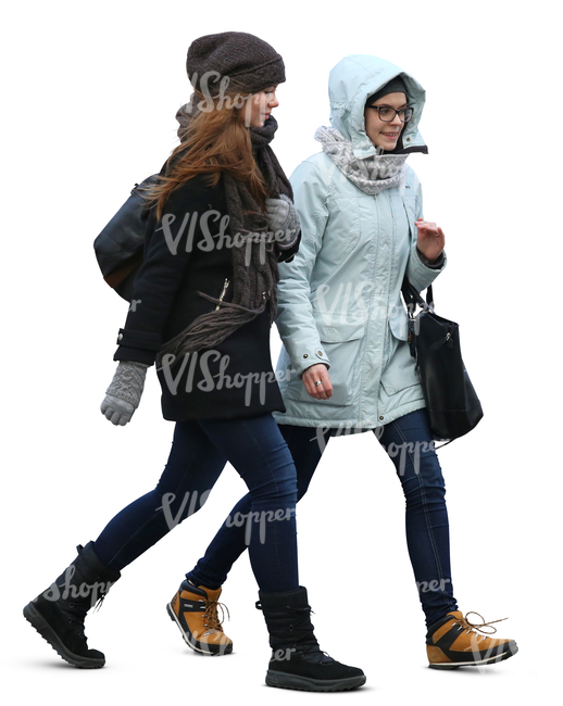 two teenage girls in winter coats walking side by side