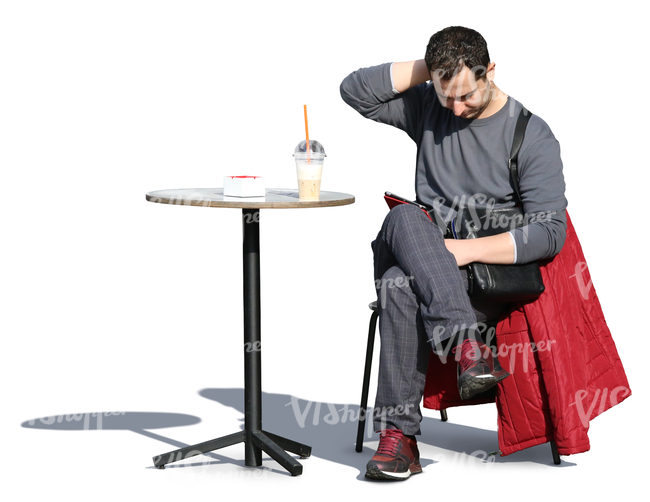 man sitting in a cafe and looking at his tablet