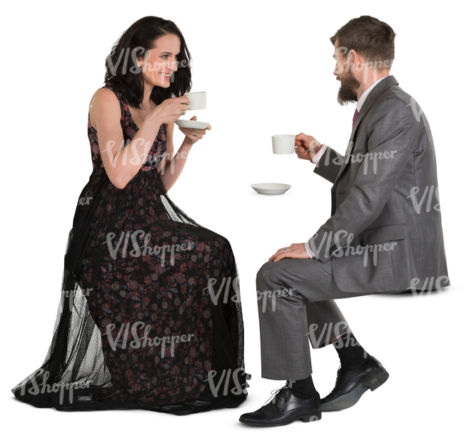 man and woman in fancy clothes sitting in a cafe