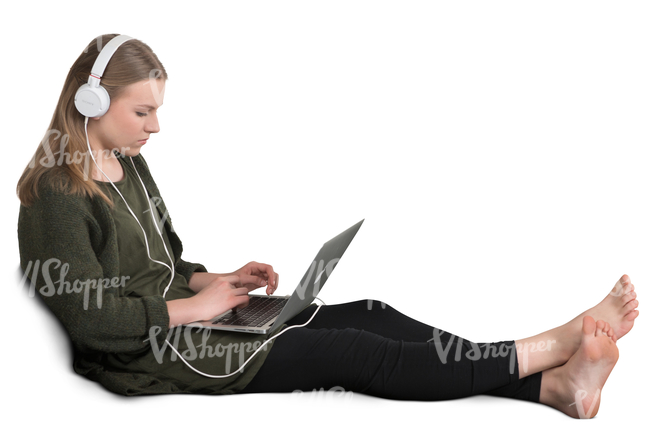 girl sitting on a couch and listening to music from her laptop