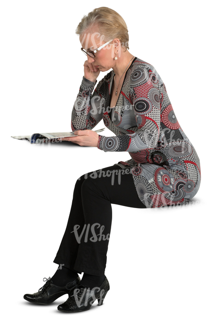 woman sitting at the table and reading a newspaper