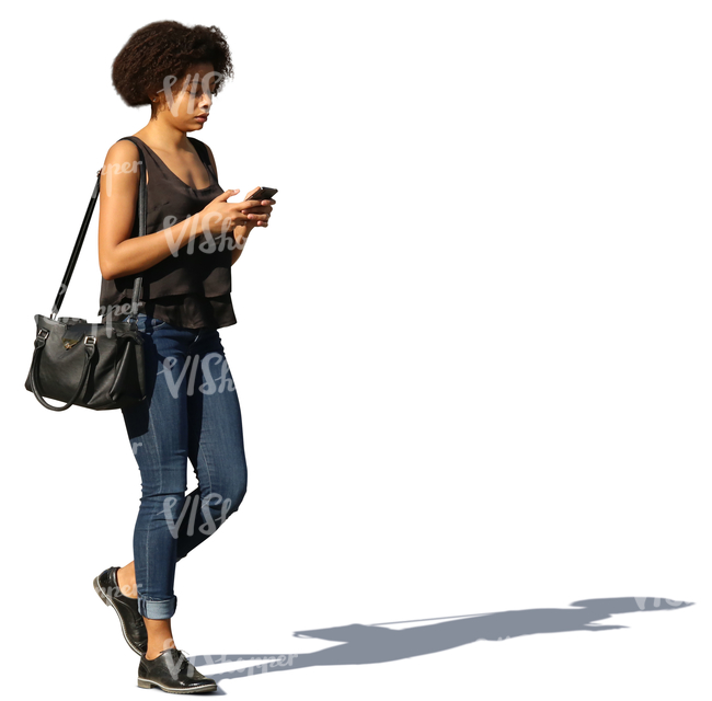 african woman walking and texting