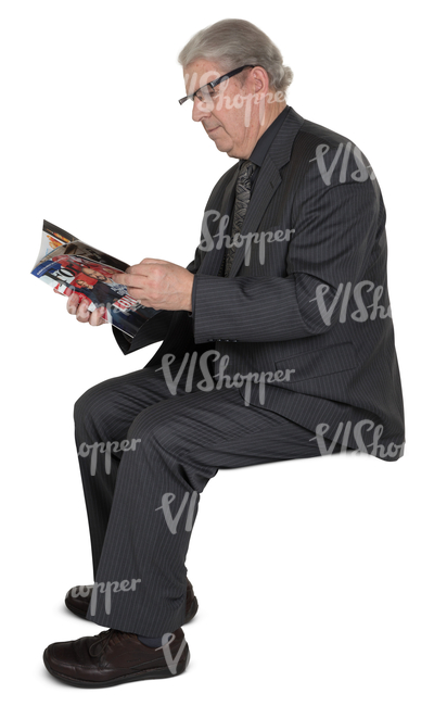 elderly man in a suit sitting and reading a newspaper