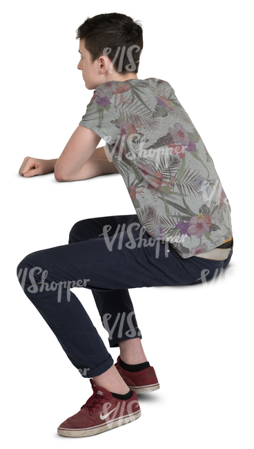 teenage boy sitting behind a table