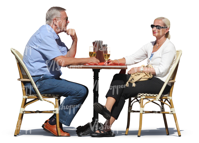 man and woman sitting in a cafe and drinking wine