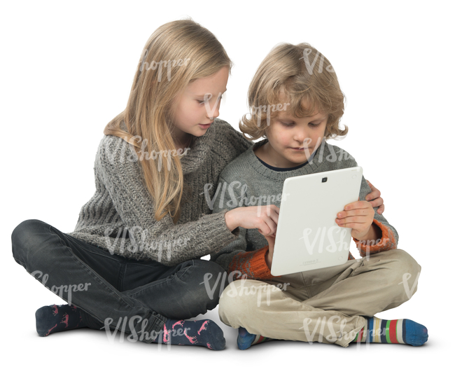 little boy and girl sitting on the floor and looking at ipad