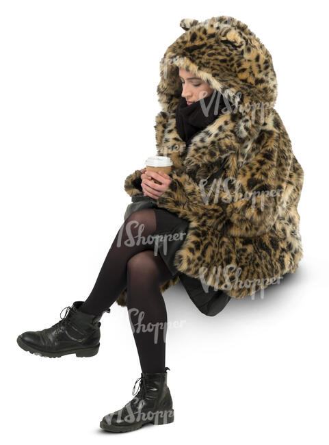 woman in a faux fur coat sitting and drinking coffee