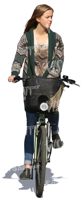 woman in a cardigan riding a bike