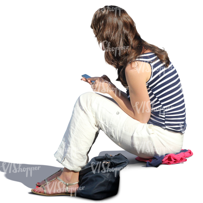 woman sitting on the stairs and looking at her phone