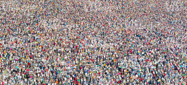 a large crowd standing and listening to a concert