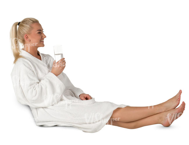 woman in a white bathrobe sitting in a spa