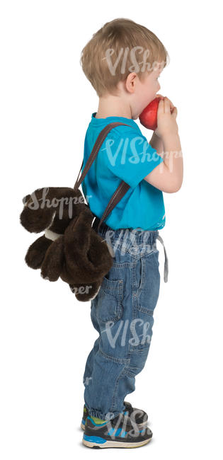 little boy standing and eating an apple