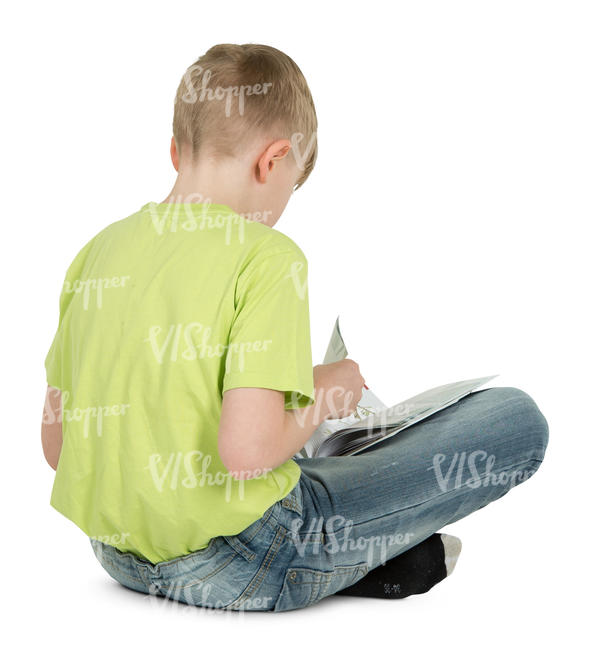 boy sitting on the floor and reading a book