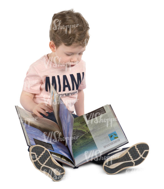 boy sitting on the floor with a book