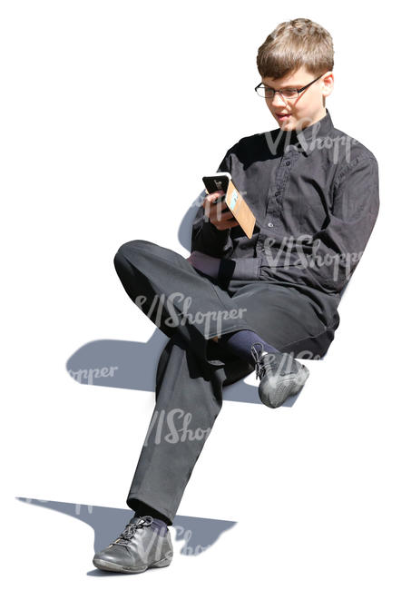 teenage boy sitting and texting