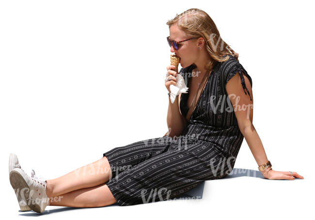 woman sitting on sidewalk and eating ice cream