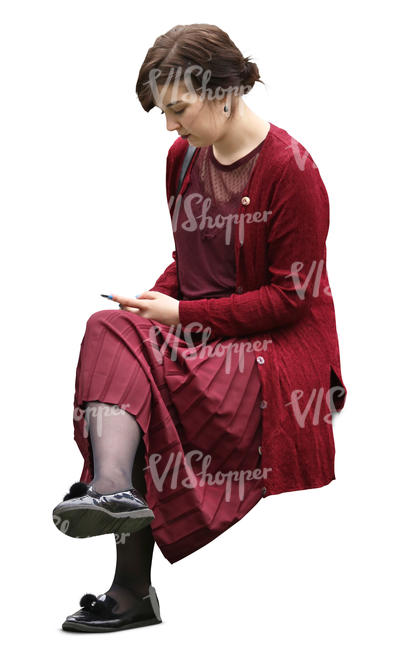 woman in a red costume sitting and texting