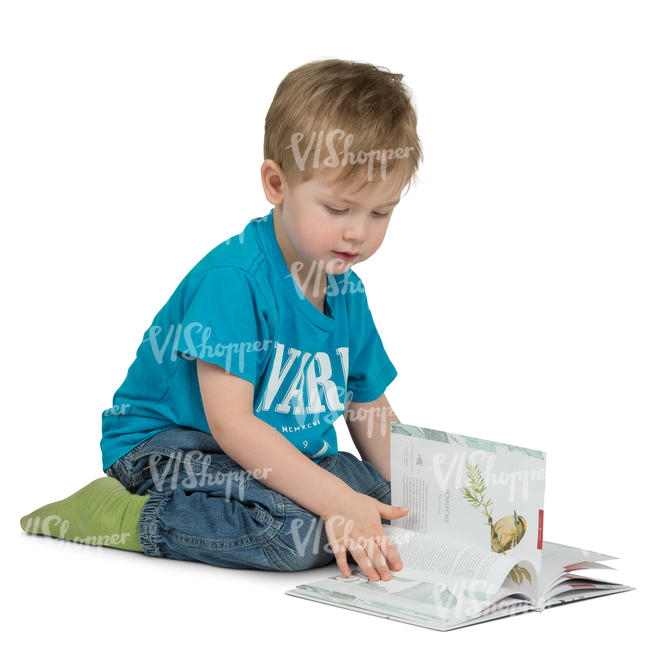 young boy sitting onn the floor and reading a book