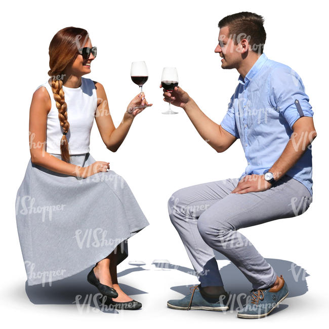 man and woman sitting in a cafe and drinking wine