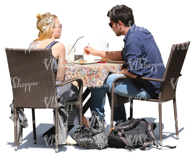 man and woman sitting in a cafe and eating