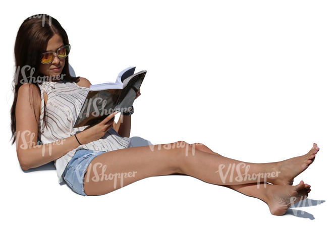 woman lying on lounge chair and reading a book
