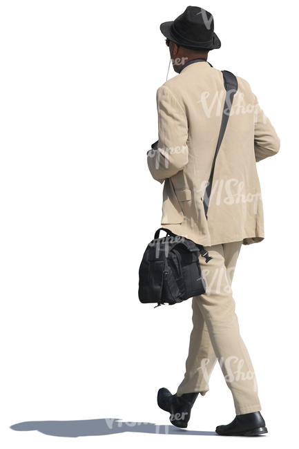 african man in a beige suit walking