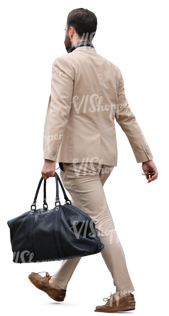 man in a beige suit carrying a bag