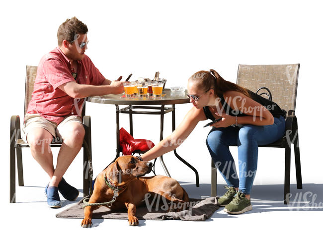 man and woman with a dog sitting in a cafe