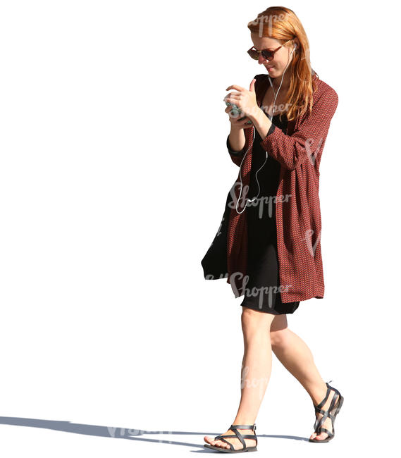 woman walking and looking at her phone