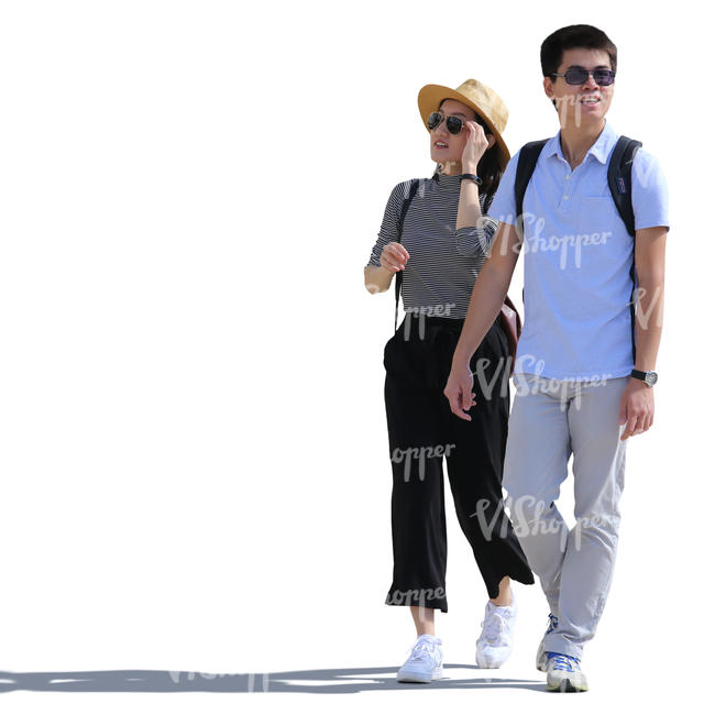backlit asian couple walking on the street