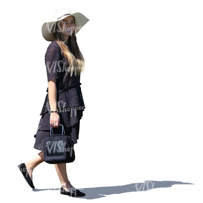 backlit woman in a black summer dress walking