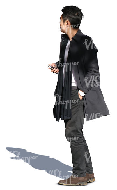 asian man wearing a black coat standing