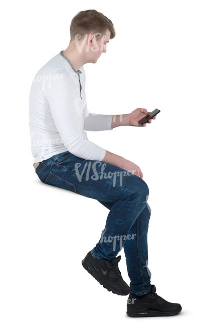 man sitting on a bar stool and texting