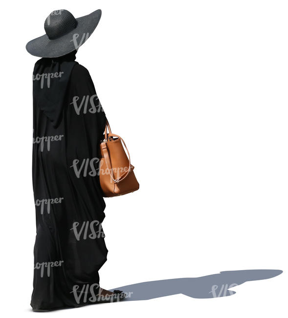 woman with a big hat and black cape walking
