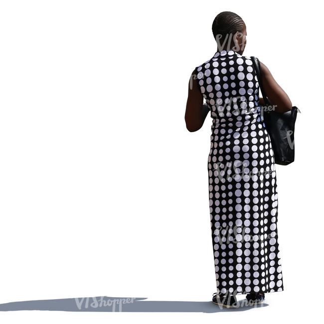african woman in a long monochrome dress stanting