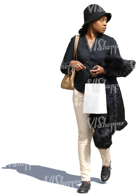black woman walking with a shopping bag in hand