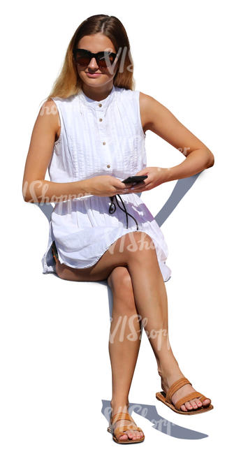 woman in a white summer dress sitting