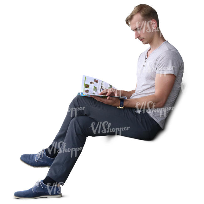 man sitting and reading a magazine