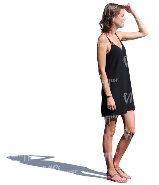 woman in a black summer dress standing and looking