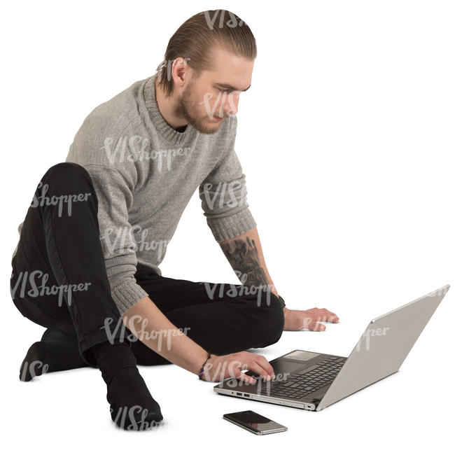 man sitting on the floor and working with laptop