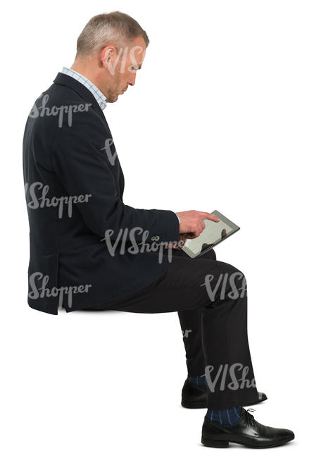 businessman sitting and checking his tablet