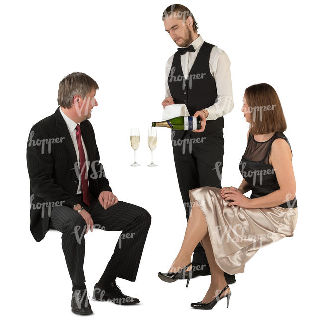 couple sitting in  a restaurant and waiter pouring out champagne