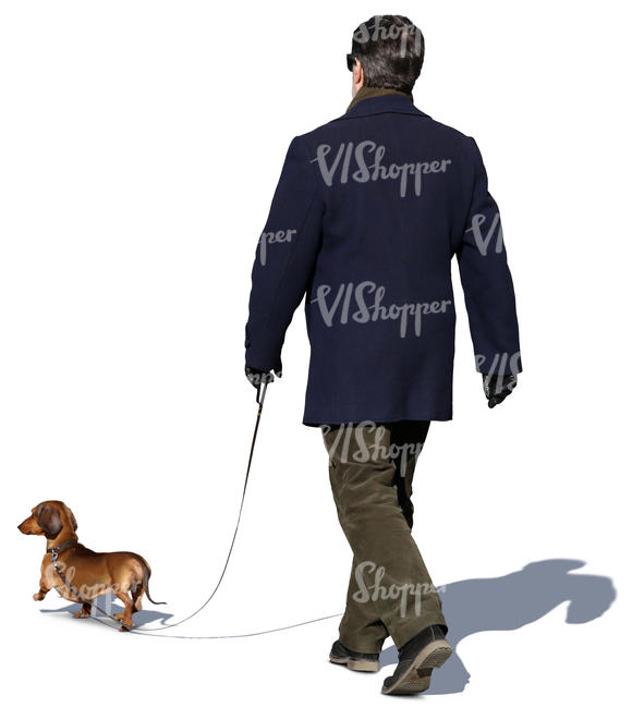 man in a dark blue coat walking a dog