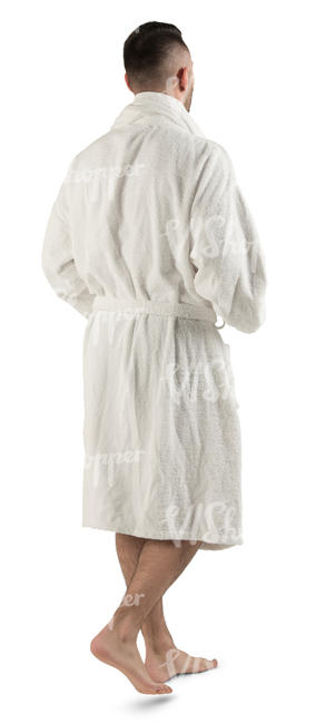 man in a white bathrobe walking